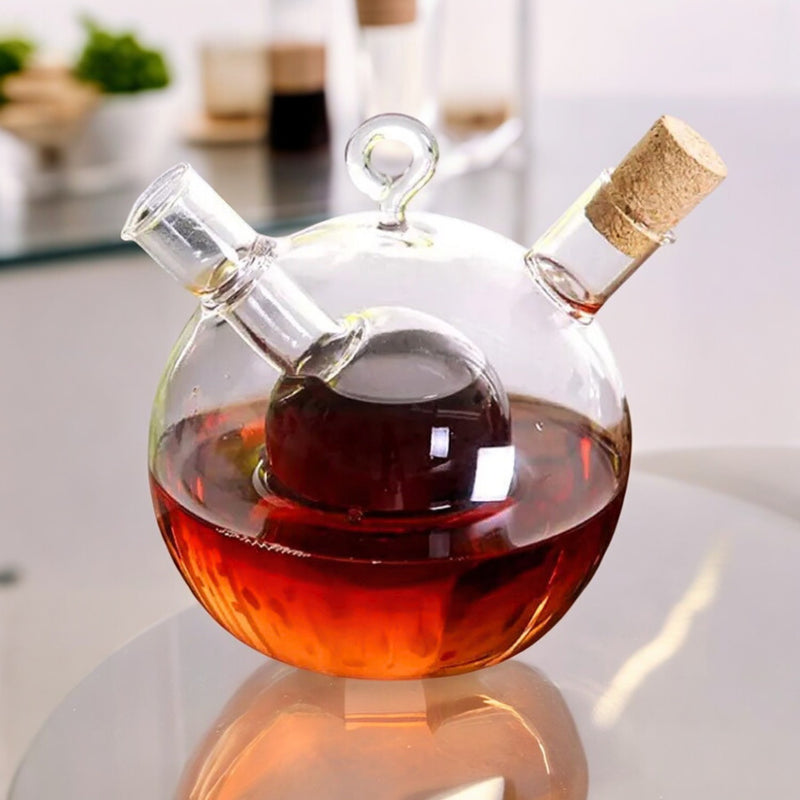 Round glass oil and vinegar dispenser filled with oil and balsamic vinegar