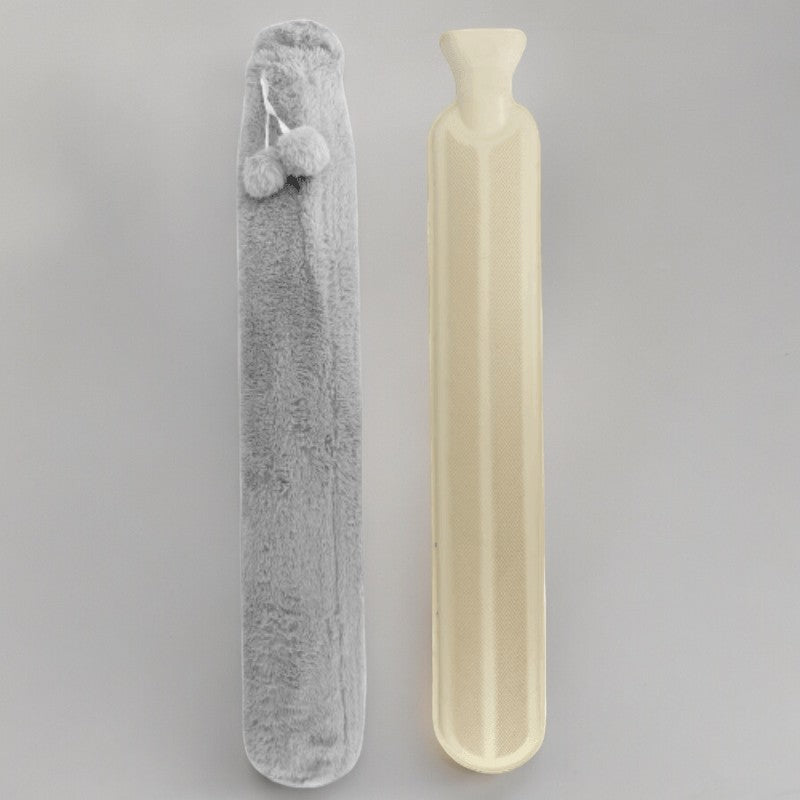 Long rubber hot water bottle beside its grey fleece cover