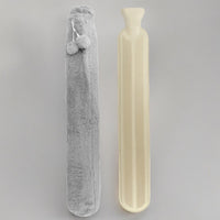 Long rubber hot water bottle beside its grey fleece cover
