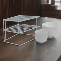 White kitchen shelf organiser on a worktop beside bowls