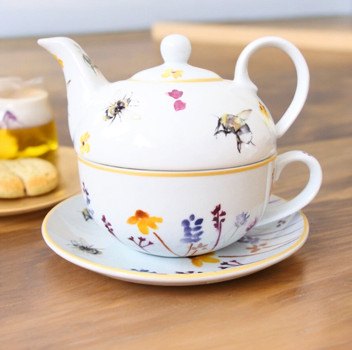 Busy Bee fine china teapot stacked on its cup and saucer, with bee and flower artwork