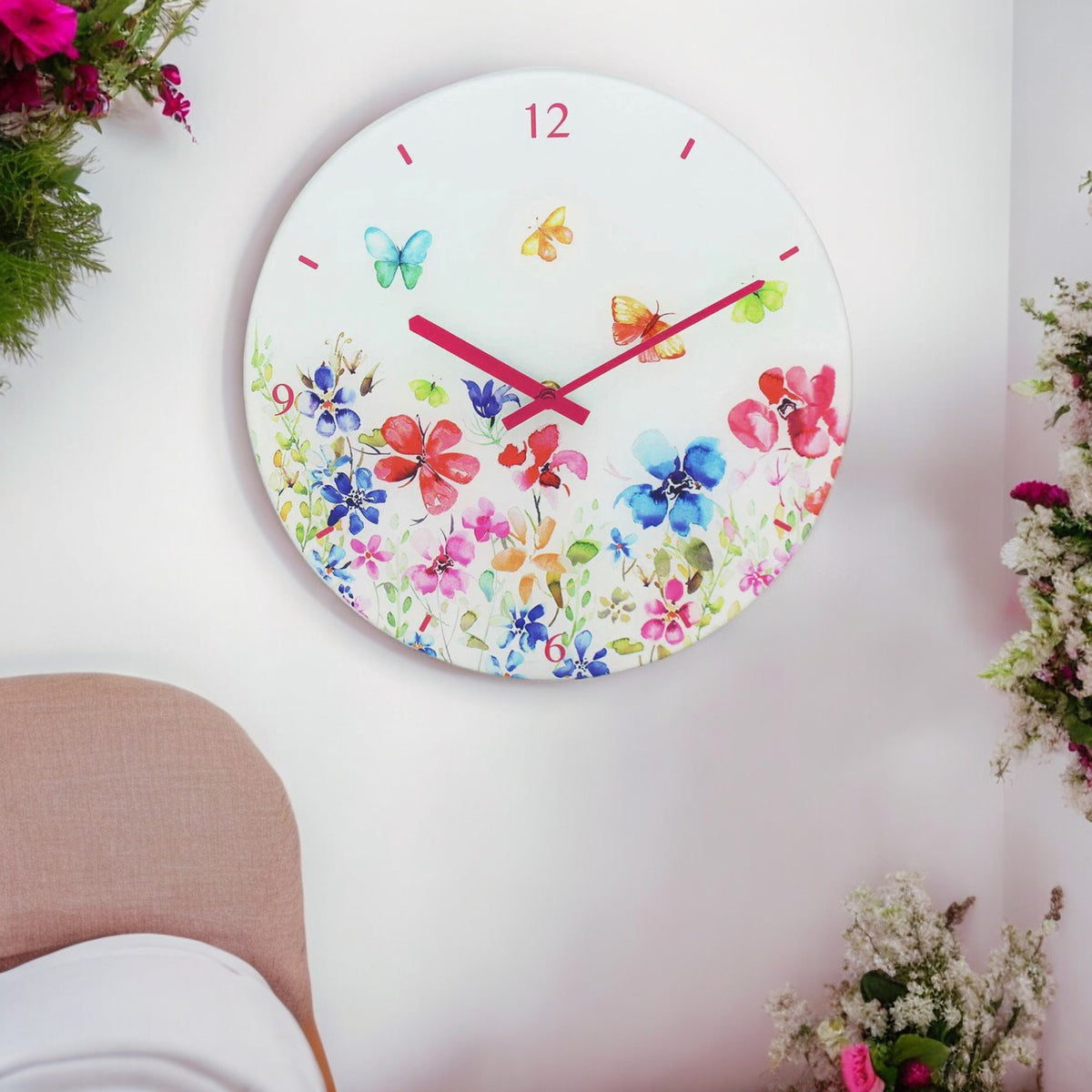 Round Butterfly Meadow glass wall clock with pink hands, colourful flowers and butterflies