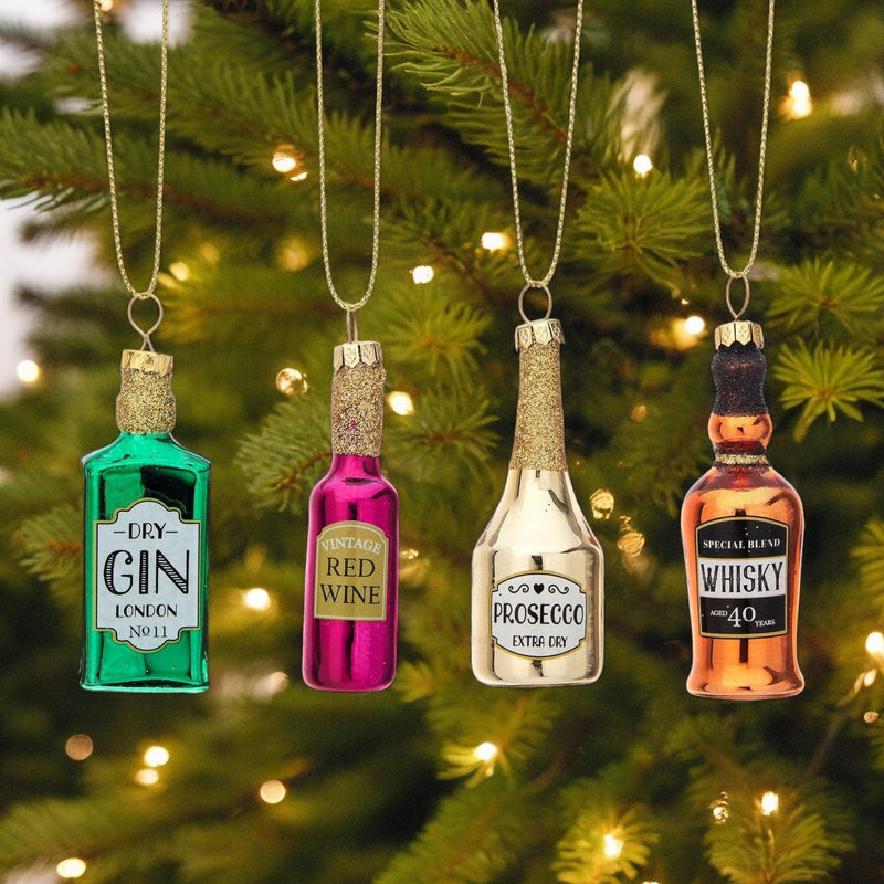 Gin, red wine, prosecco and whisky bottle-shaped glass baubles hanging on a Christmas tree