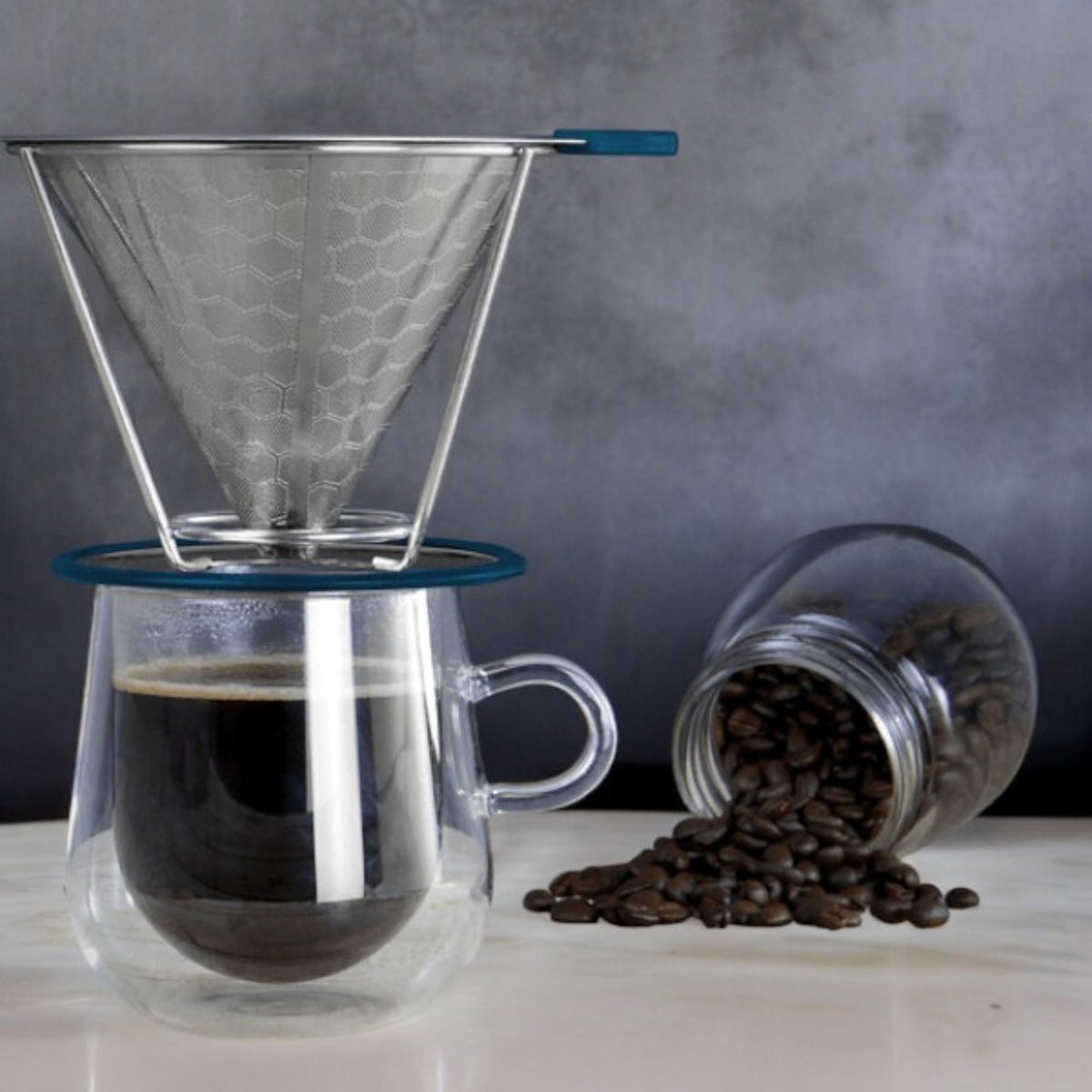 Pour-over coffee being prepared into a double-walled mug