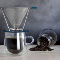 Pour-over coffee being prepared into a double-walled mug