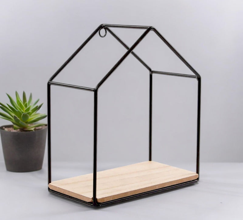 Black house-shaped wall shelf with an open metal frame and natural-coloured base