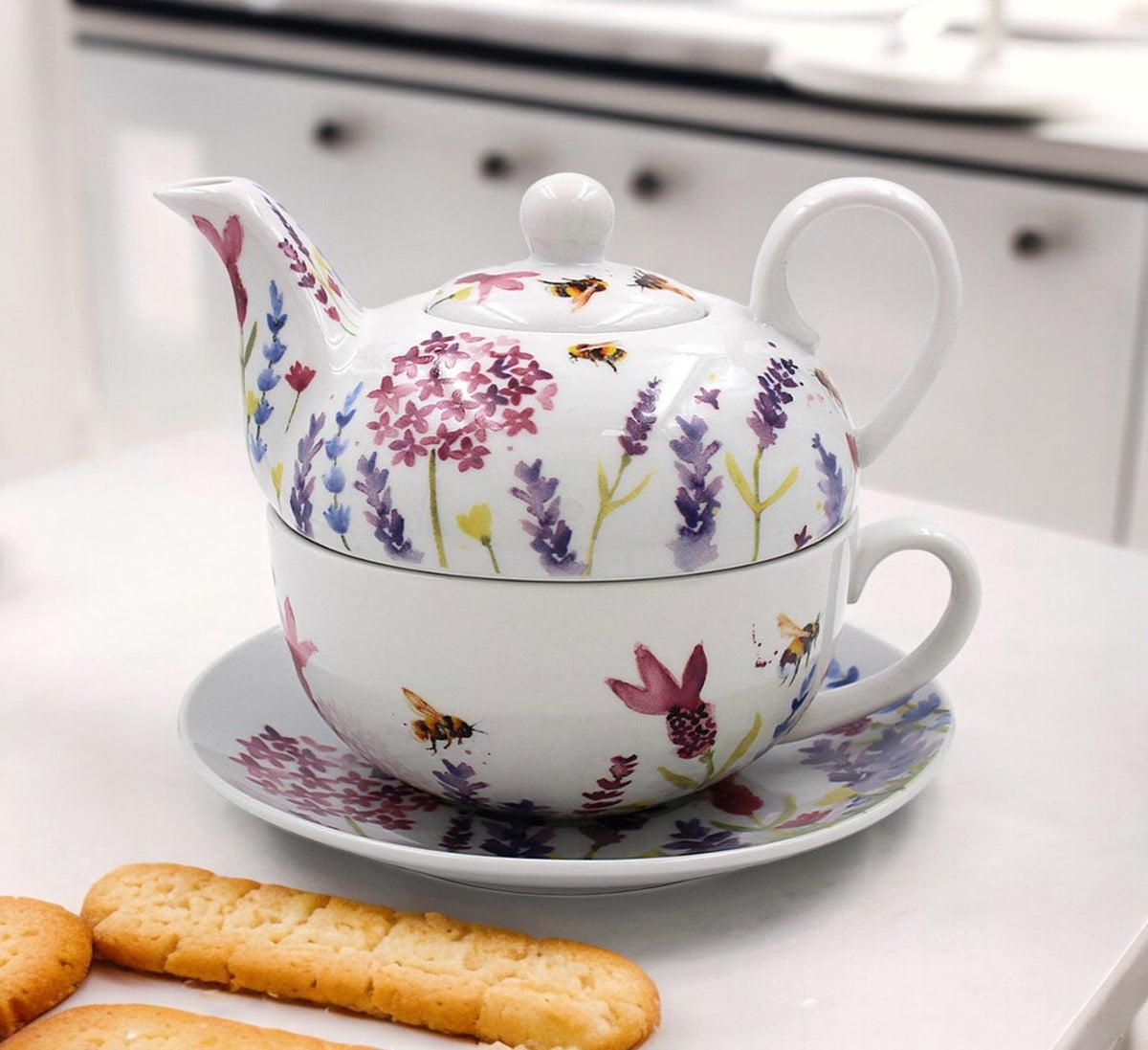 Lavender and bees teapot stacked on its matching cup and floral saucer