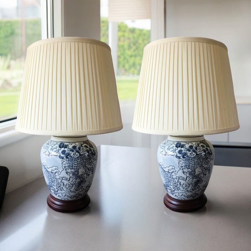 Pair of blue and white Japanese Wave porcelain lamps with ivory pleated shades
