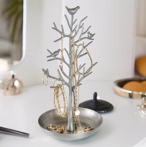Silver bird jewellery tree stand with round dish displaying necklaces and earrings
