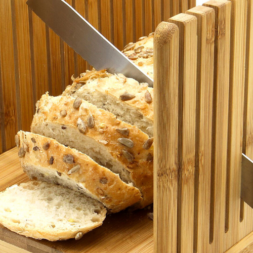 Bamboo Bread Slicer with a loaf of bread, showcasing its eco-friendly and natural bamboo construction