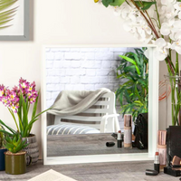 White deep box square mirror styled on a dressing table