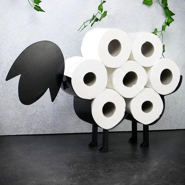 Black sheep toilet roll holder filled with seven white rolls in a bathroom