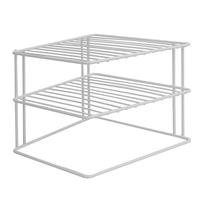Angled view of the white two-tier steel cupboard shelf
