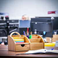Bamboo desk organiser positioned beside an open notebook