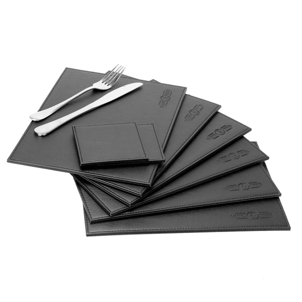 Black faux leather placemats and coasters arranged with cutlery