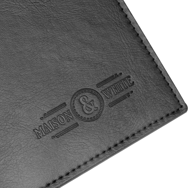 Stitched edge and embossed maker's mark on a black placemat