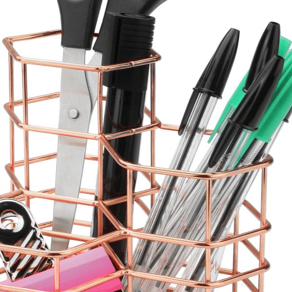 Close-up of pens and scissors in the rose gold wire compartments