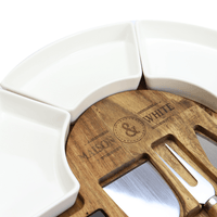 Three curved ceramic dishes around the acacia cheese board