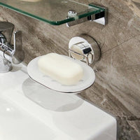 Wall-mounted suction soap dish holding a bar of soap beside a bathroom basin