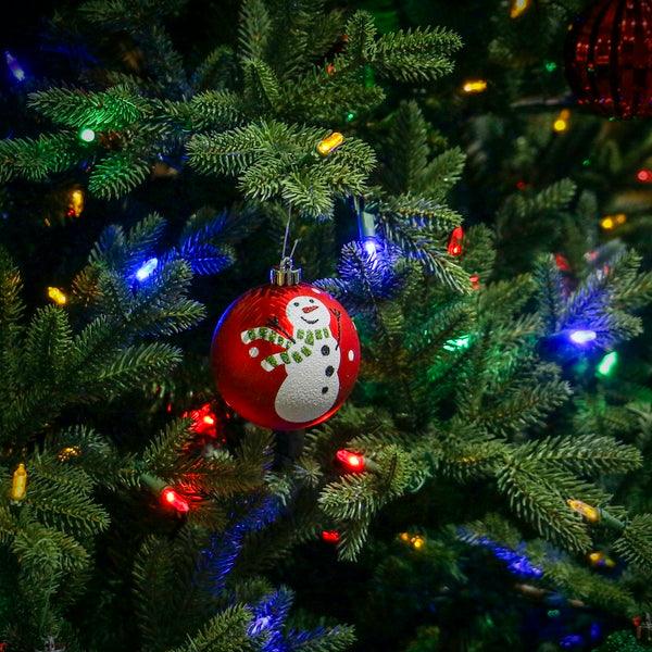 Multicoloured LED lights among Christmas tree branches and ornaments