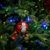 Multicoloured LED lights among Christmas tree branches and ornaments