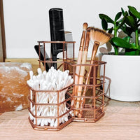 Rose gold organiser holding makeup brushes, cosmetics and cotton buds