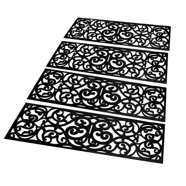 Four black rubber stair treads with decorative scroll patterns
