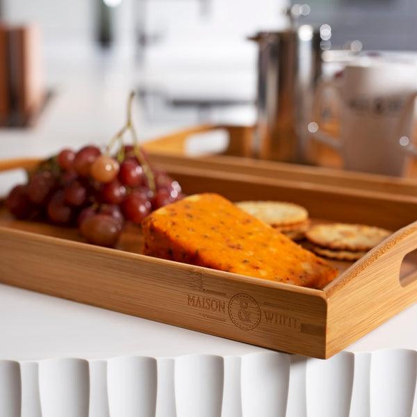 Bamboo tray holding fruit, snacks and a coffee pot