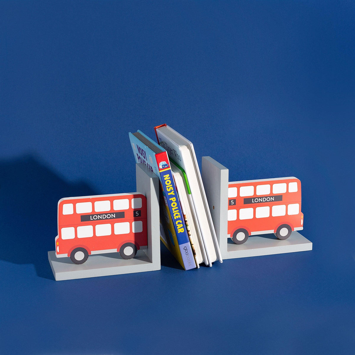 London bus bookends holding books against a dark blue background