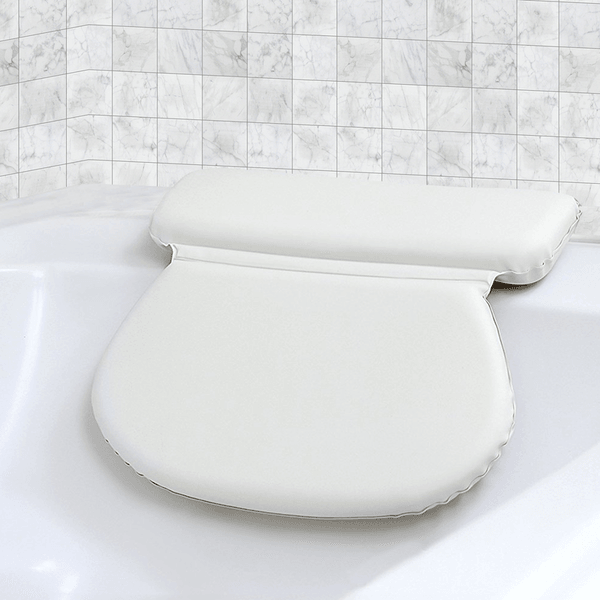 White cushioned bath pillow resting against the back of a bathtub