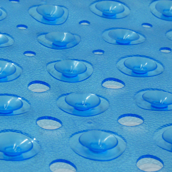 Close-up of suction cups and drainage holes on the blue bath mat
