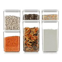 Six clear food storage containers in three sizes filled with dry ingredients