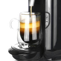 Coffee pouring into a handled double-walled glass mug