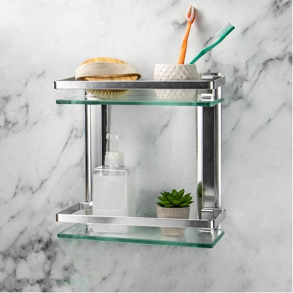 Two-tier glass bathroom wall shelf holding toiletries against a marble-effect wall