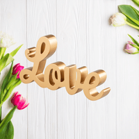 Angled view showing the thickness of the gold Love lettering