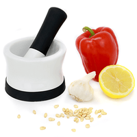 White ceramic pestle and mortar with black silicone base and handle grip