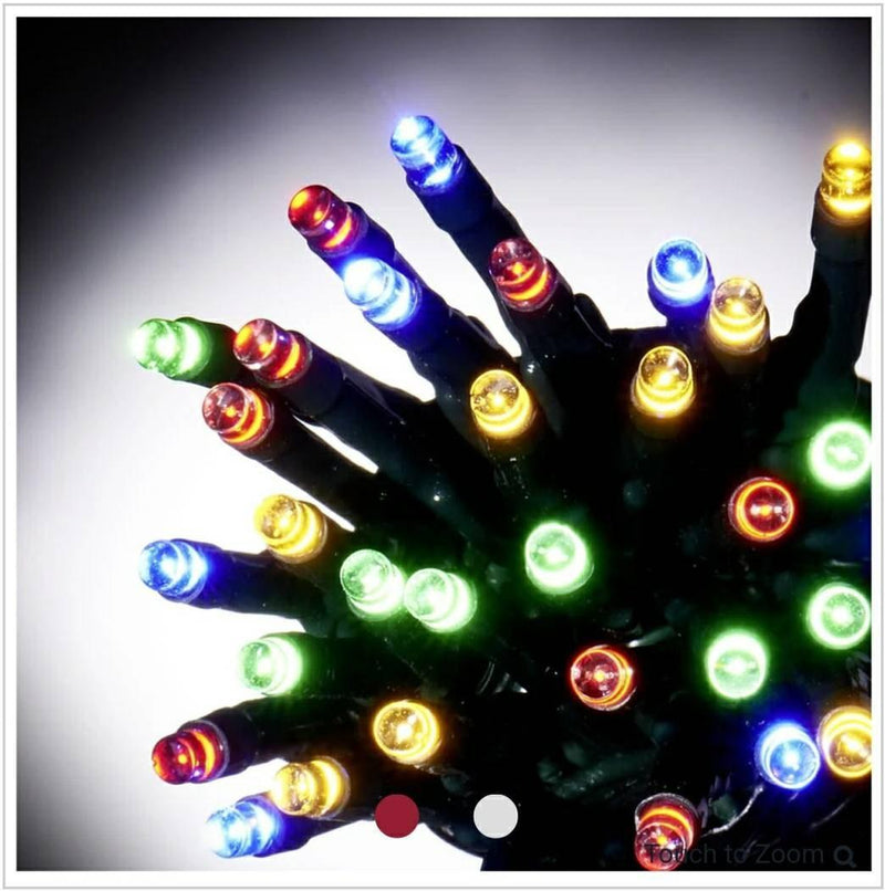 Multicoloured LED Christmas string lights glowing on a dark green cable