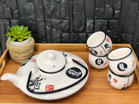 Close view of the dragon character decoration on the white porcelain tea set