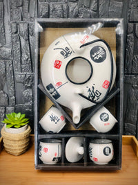 White dragon teapot and cups in their black presentation box