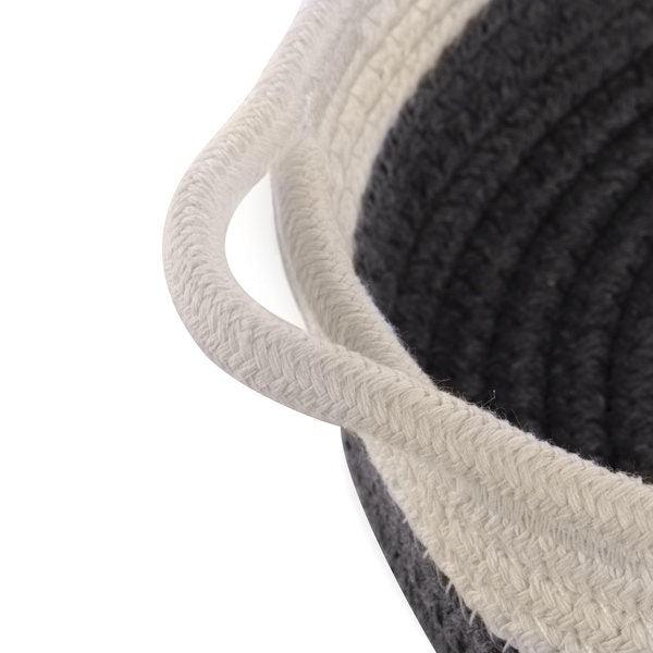 Close-up of white rope handle and grey basket weave