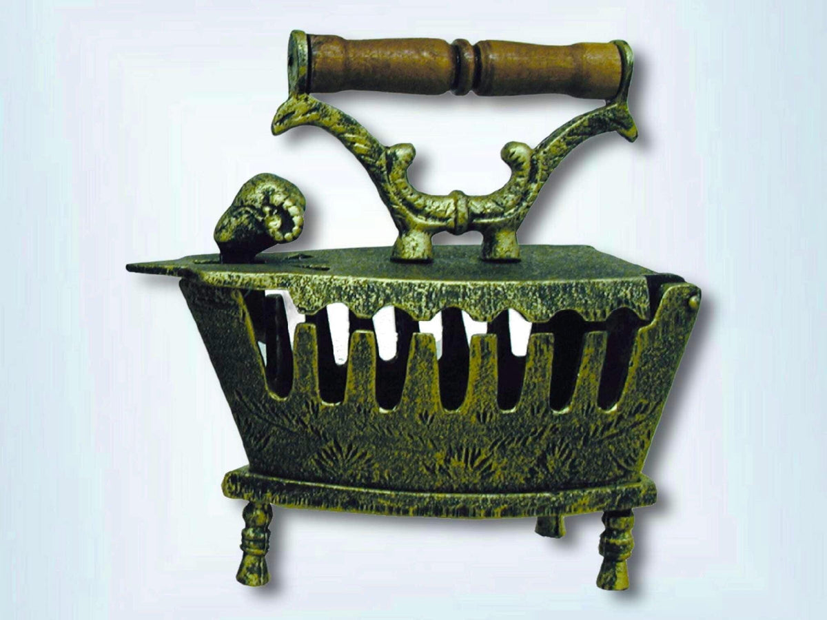 Decorative antique-gold cast iron coal iron on its stand with wooden handle