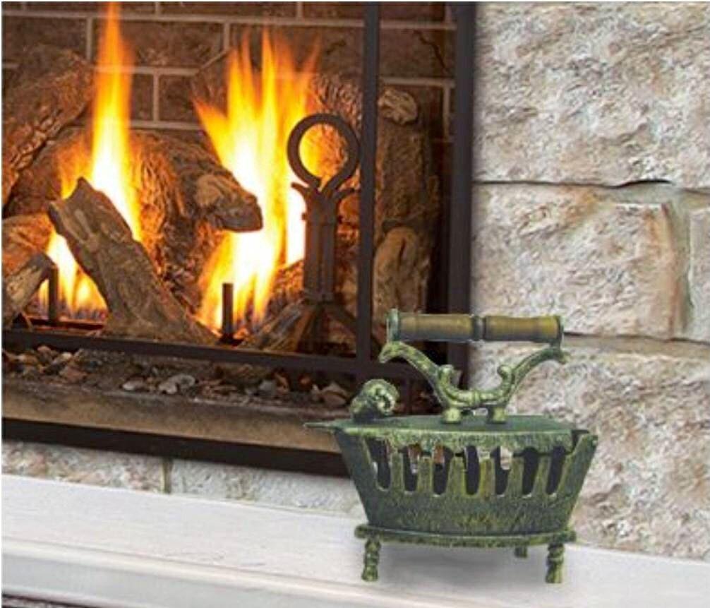 Vintage-style decorative coal iron displayed beside a fireplace