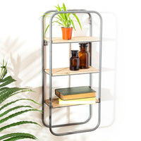 Three-tier industrial wall shelf displaying a plant, bottles and books