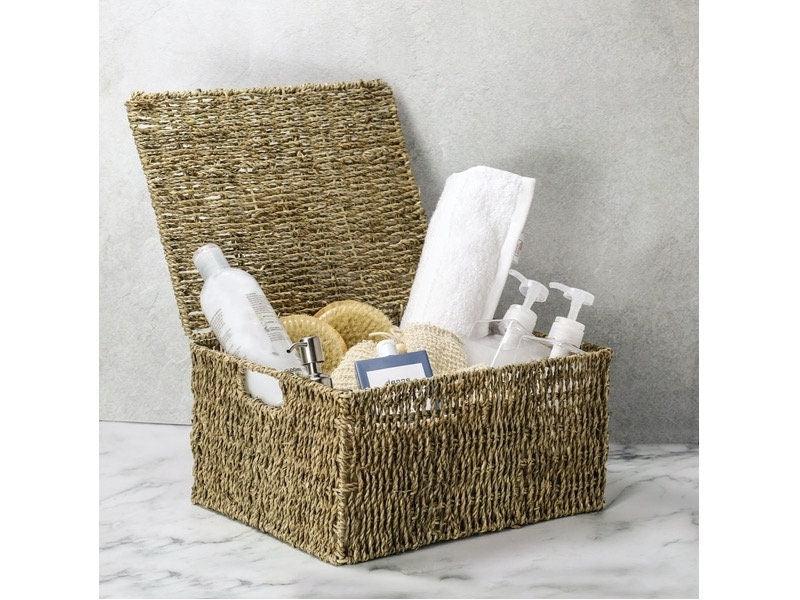 Seagrass basket holding toiletries and a rolled towel