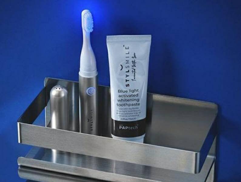 STYLSMILE sonic blue-light toothbrush and toothpaste displayed on a bathroom tray