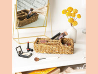 Four-compartment typha tray used to organise makeup on a dressing table