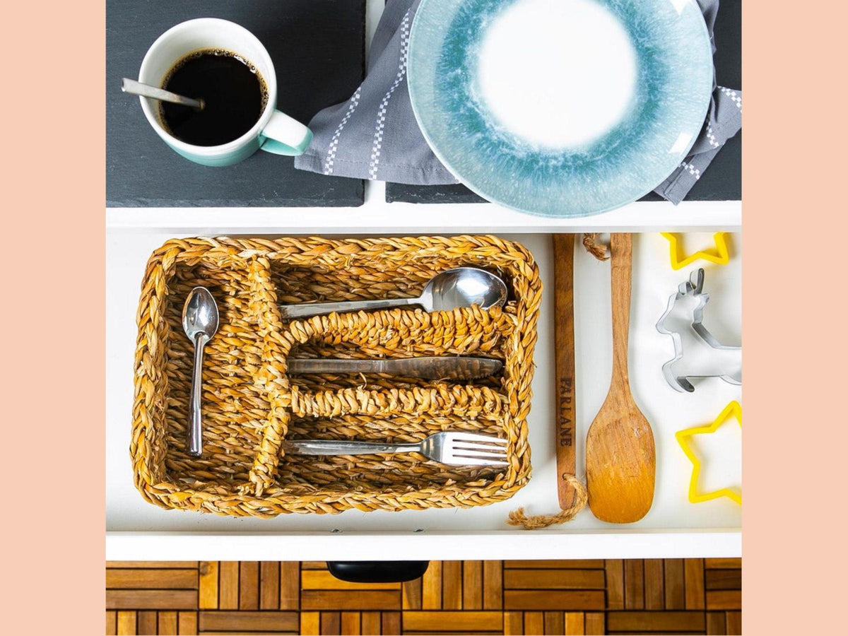 Brown woven typha organiser tray holding cutlery inside a kitchen drawer
